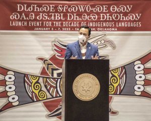 Photo of man standing at podium speaking.